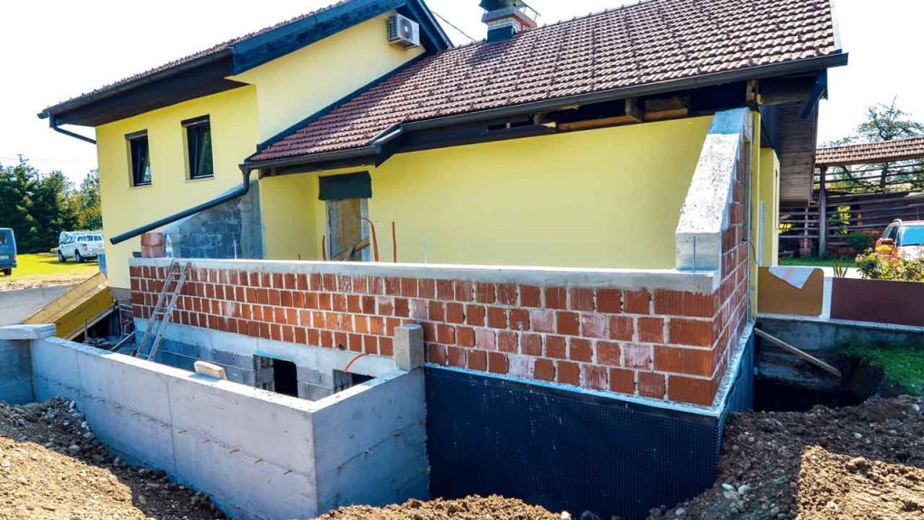 Brick extension under construction on the side of a house