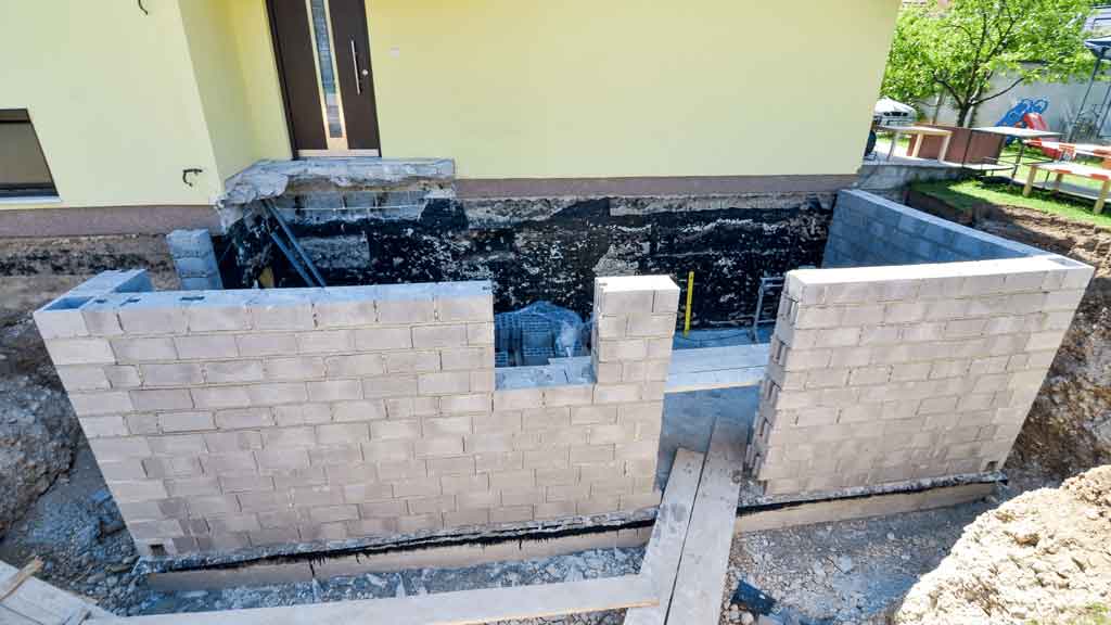Concrete block wall foundation under construction at a residential property