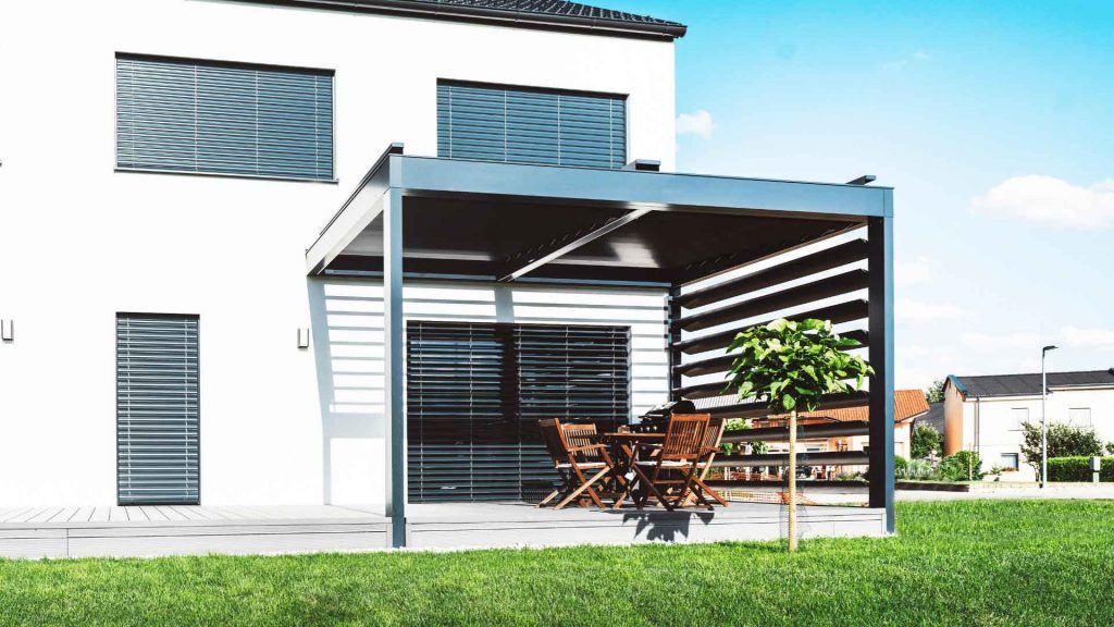 Modern attached pergola structure with outdoor dining setting