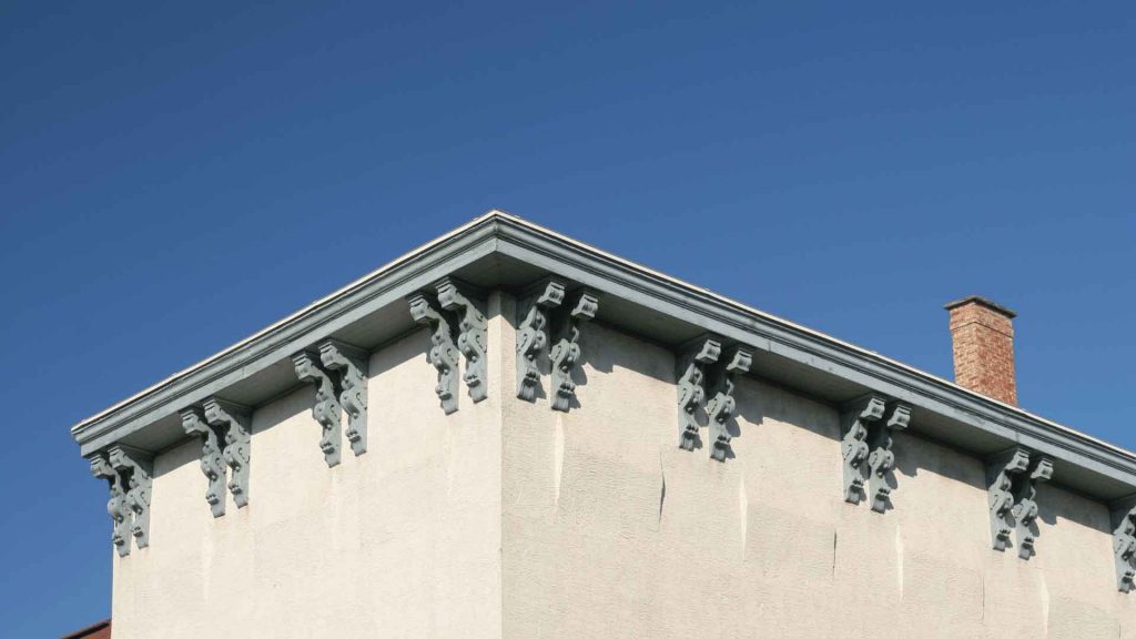 Decorative roofline brackets and eaves detail on a building corner