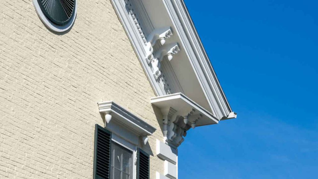 Decorative white eaves and cornice detail on a home's gable end