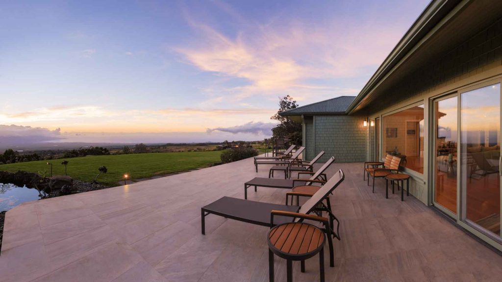 Elevated outdoor deck with sun loungers overlooking a scenic view